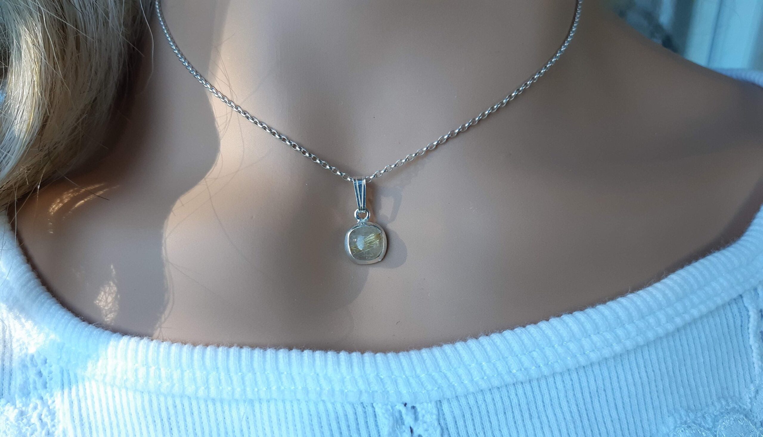 Rutilated quartz gemstone pendant set in 92.5 sterling silver