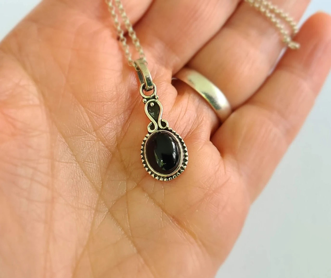 Black onyx faceted gemstone pendant set in 92.5 sterling silver